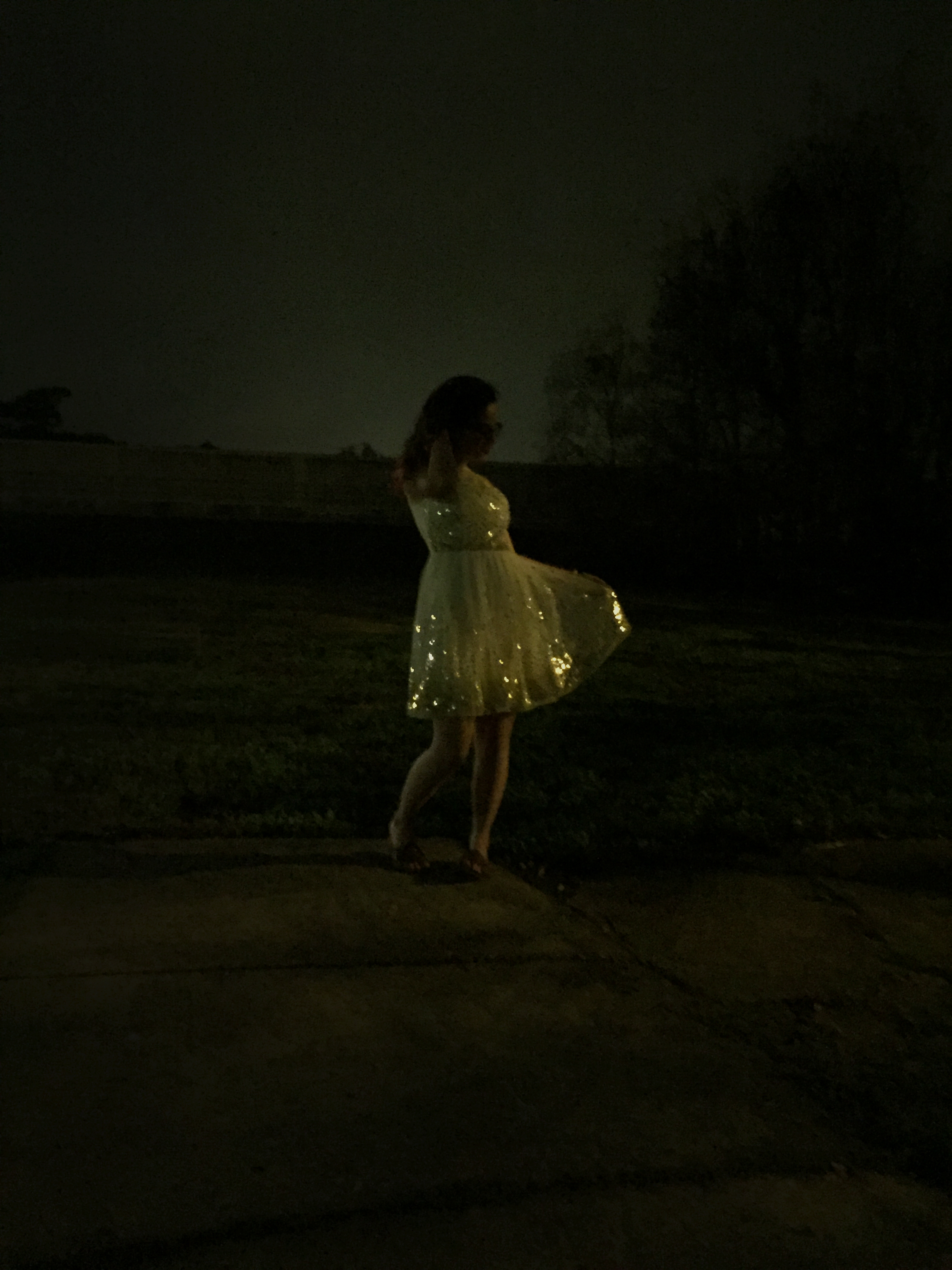 woman in sparkly dress at night