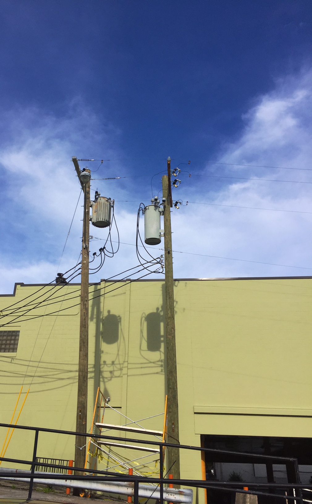 two electrical poles side by side